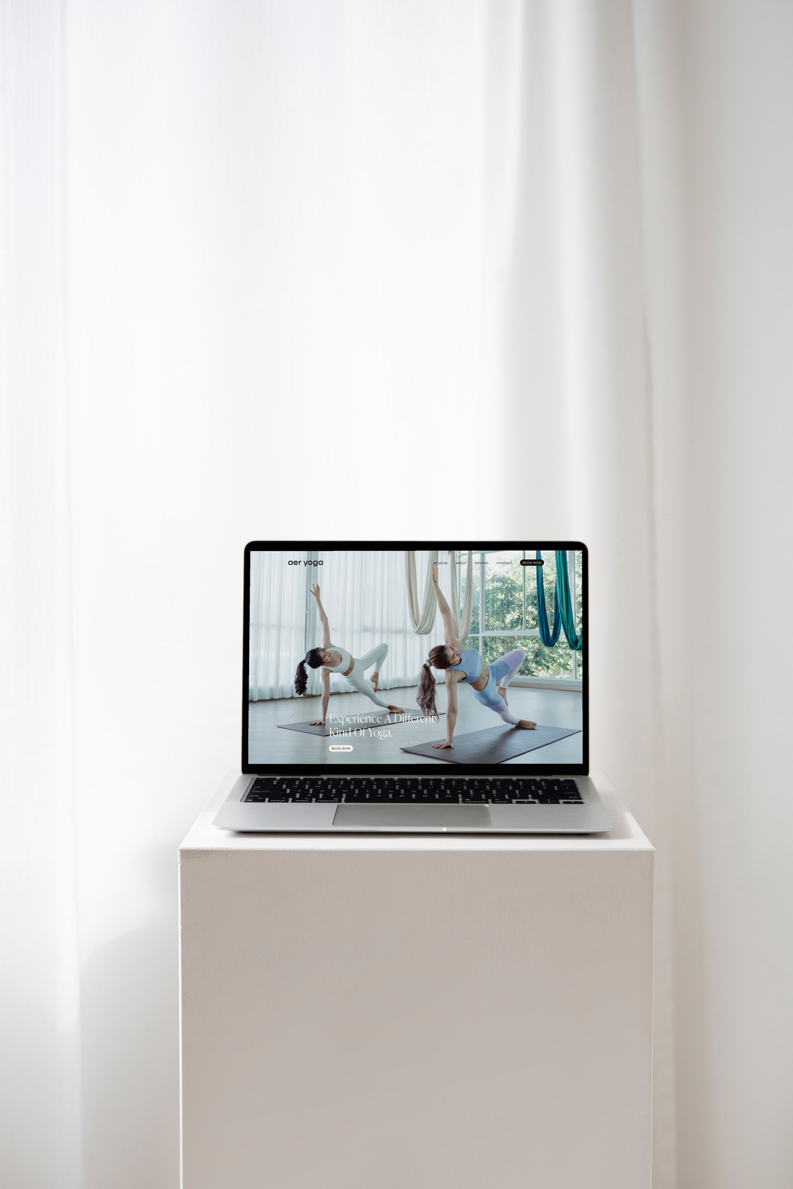 Laptop on a stand displaying a website for a yoga studio | Elisa Gilis Studio